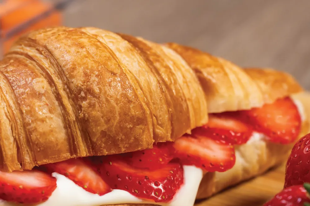 Croissant with spreadable cheese and strawberry