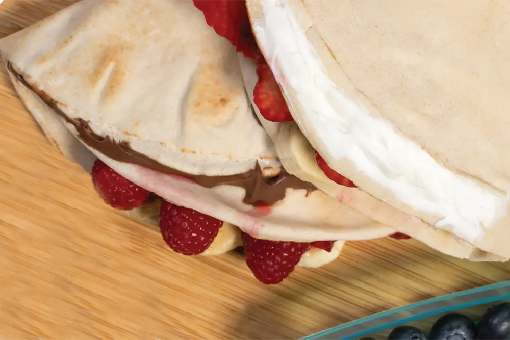 Tortilla bread with cream cheese, raspberries and banana